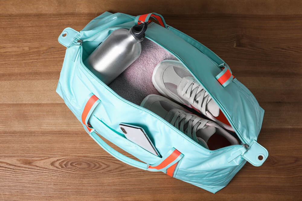 blue gym bag with towel and sneakers