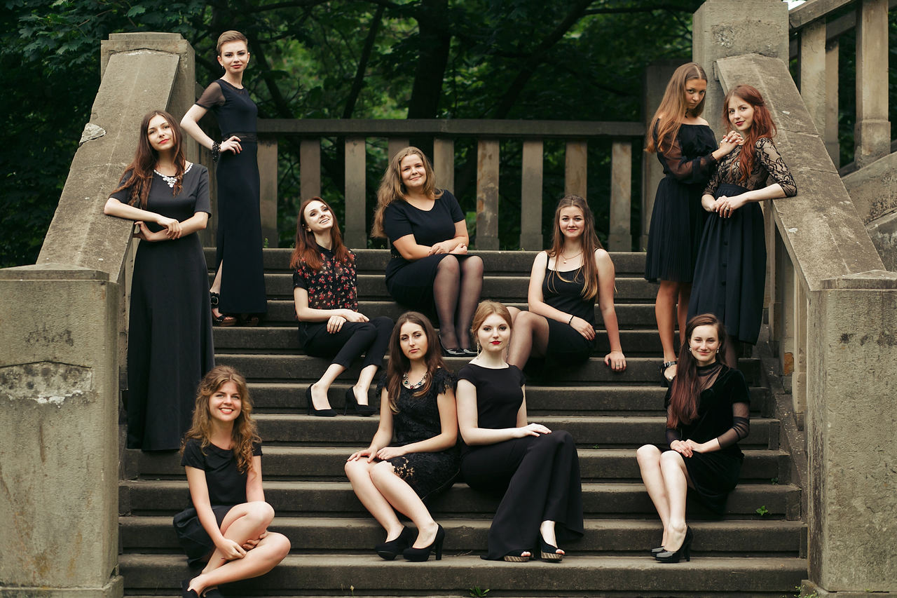 group of women wearing elegant black dresses