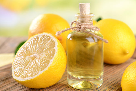 An half lemon and a bottle of lemon oil