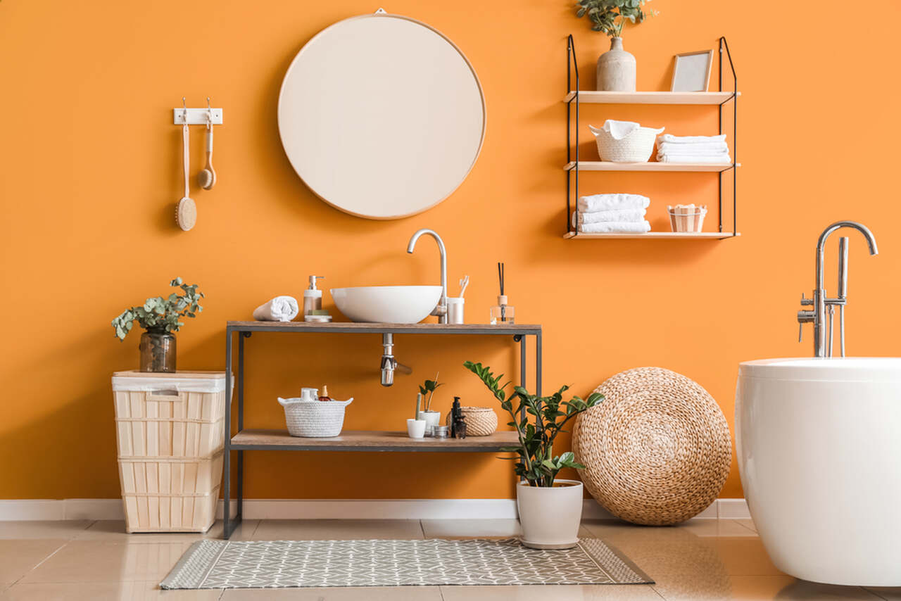 wide photograph of an orange colored bathroom