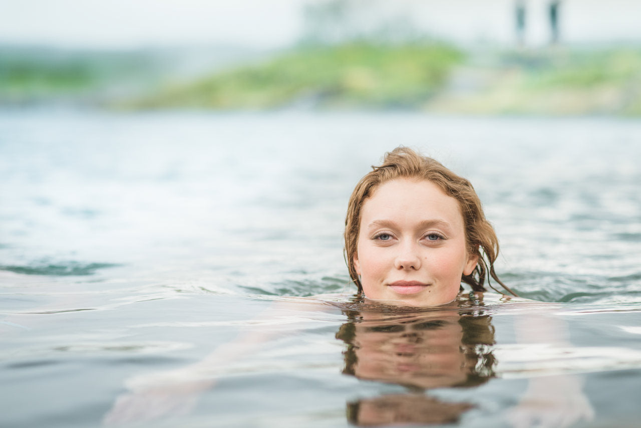 portrait of serene young woman swimming in secret