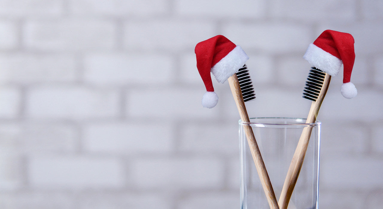 two toothbrushes with santa hats