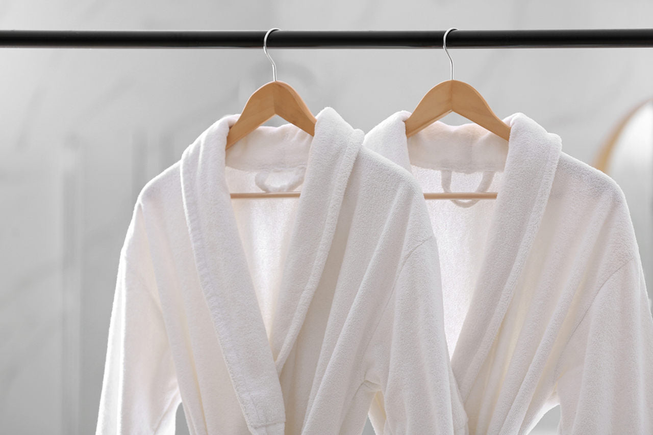 two hanged white spa robes