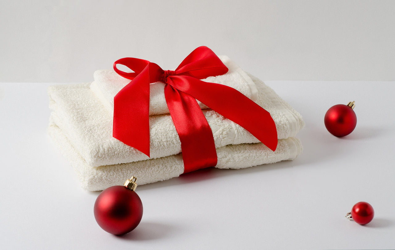folded white robe covered with red ribbon
