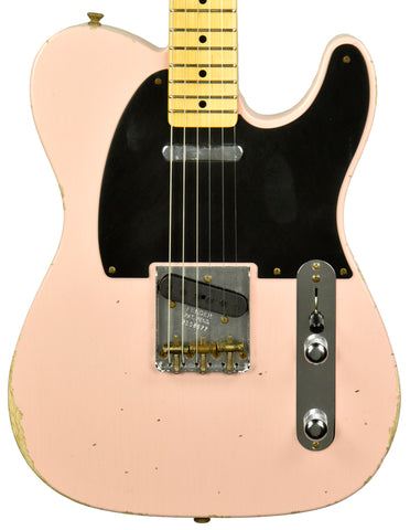 A Fender Telecaster in Shell Pink with the classic Tele pickup configuration