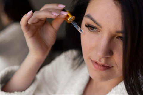 Woman using retinol on face