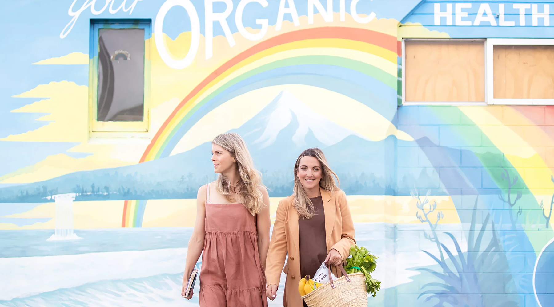 Photo of Down to Earth co-owner Lee and Lisa in front of their Taranaki artwork.