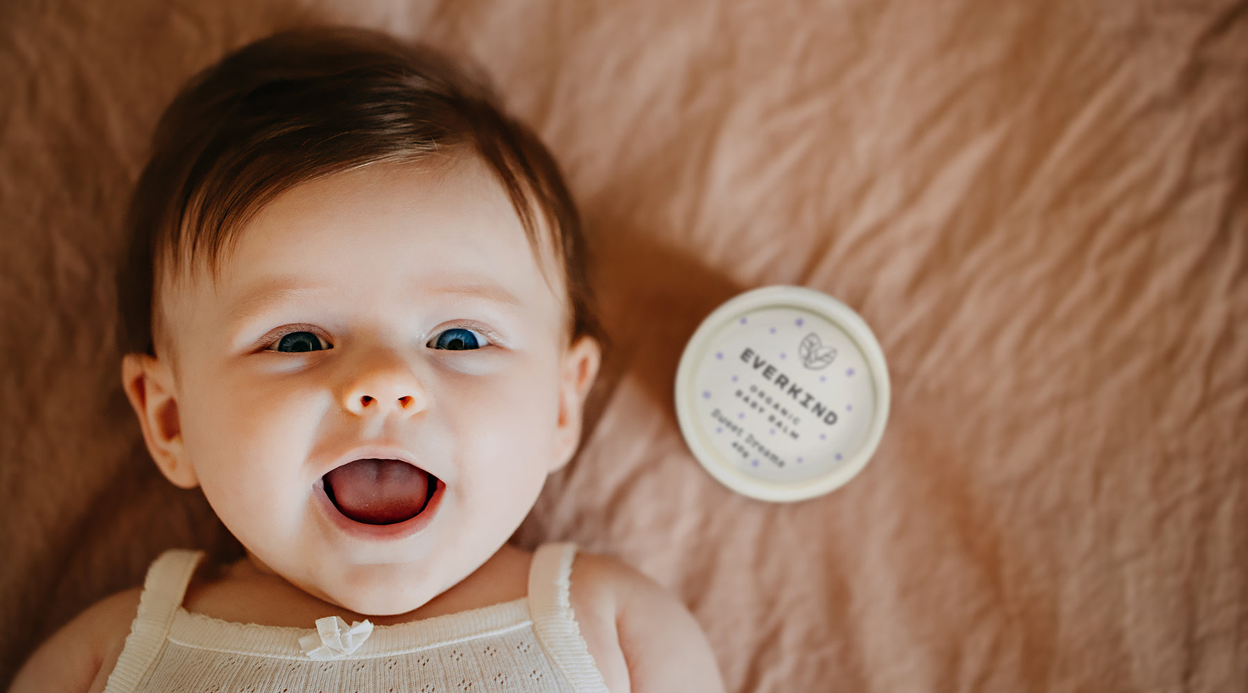 Happy baby with Everkind Sweet Dreams bedtime massage balm.