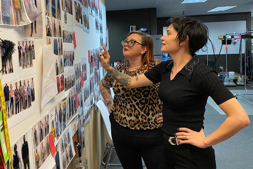 Ashely Heathcock and Alison Uhlfelder looking at the episode costume board for Magnum PI