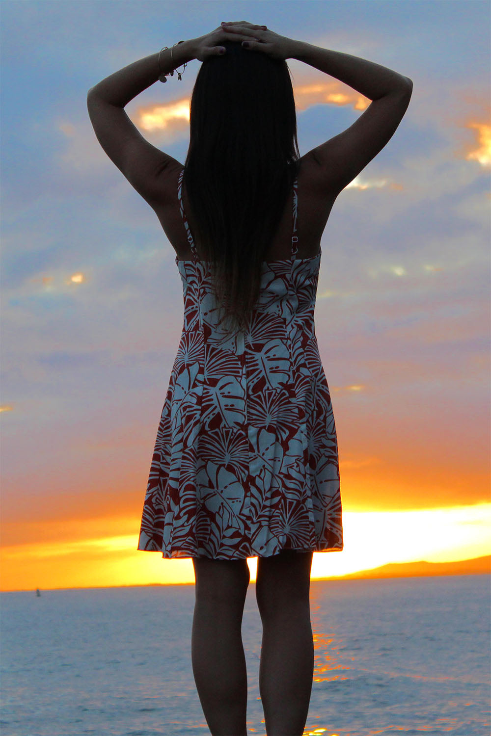 enjoying a beautiful sunset in this simple spaghetti Hawaiian dress