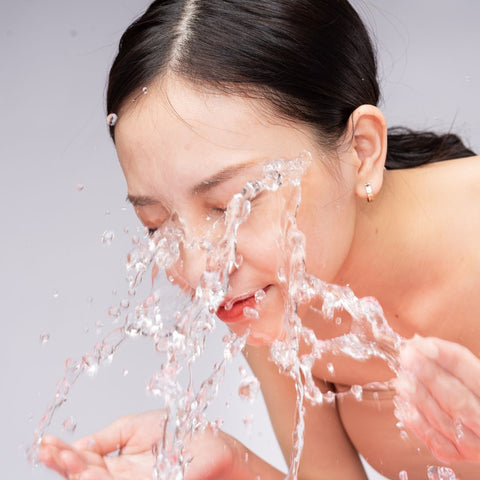 Asian Woman washing face with water