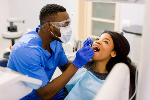Woman visiting a dentist for a checkup to address her oral wellness needs