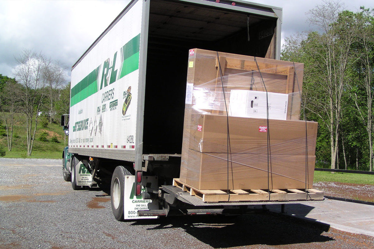 Worker delivering already assembled NewAge garage cabinets