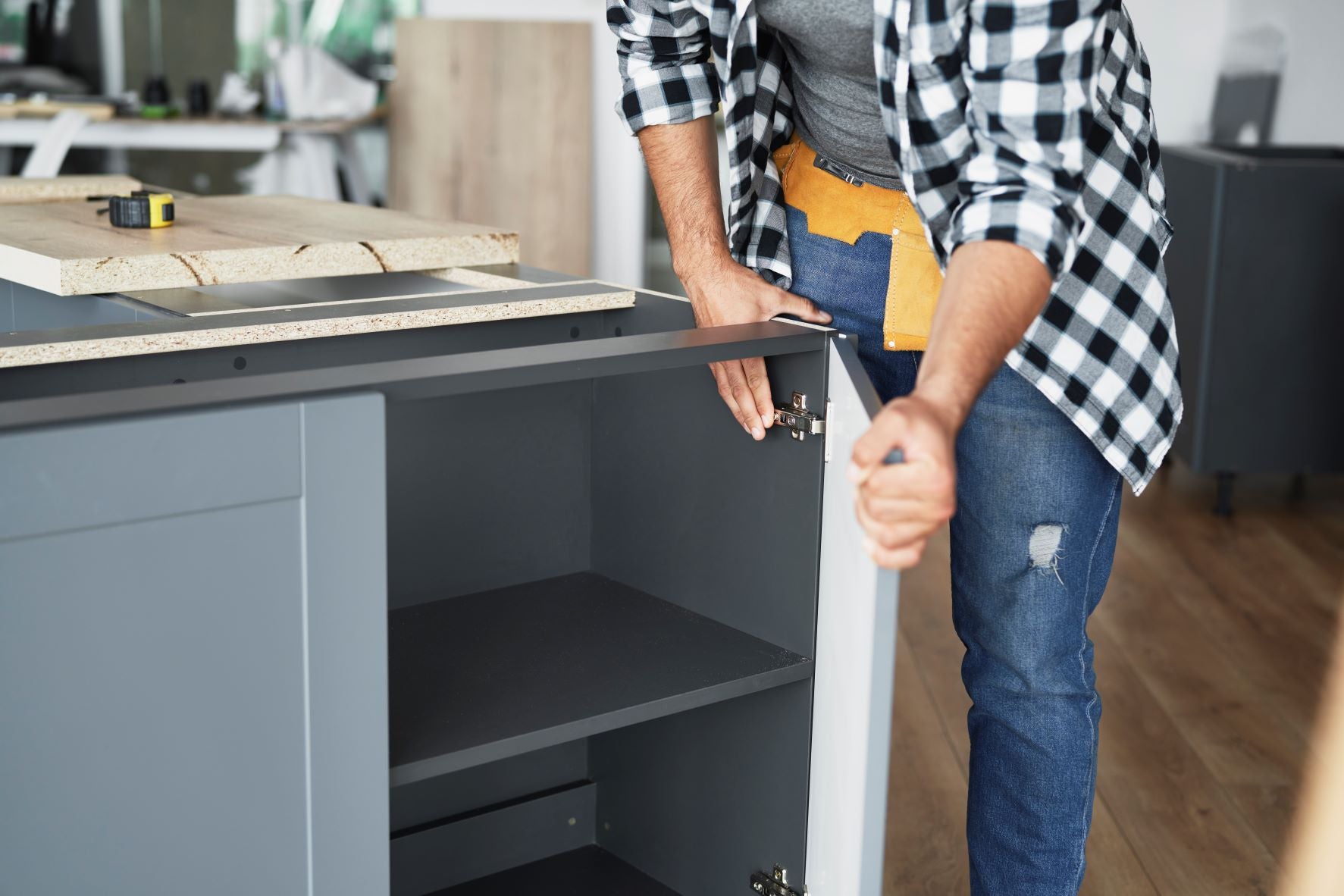 Men installing NewAge cabinet