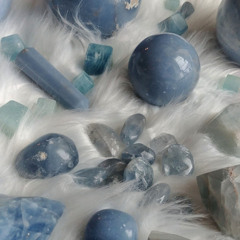 ic:A collection of polished blue minerals including Angelite, Blue Calcite, Aquamarine, and Celestite.  Can you tell the difference?