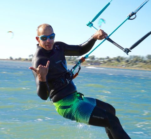 man kiteboarding sticking his tongue out