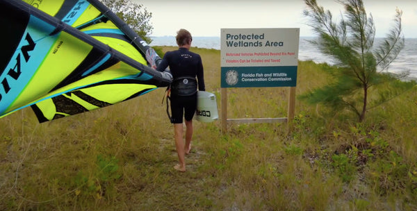 A kitesurfing walking to the launch spot at Tiera Verdi Tampa Bay