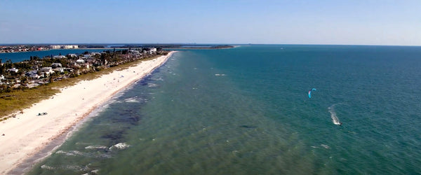 A kiteboarding at Pass-A-Grill Beach taking advantage of the deep blue water