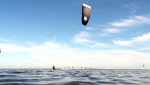A kitesurfer in front of the iconic Skyway Bridge