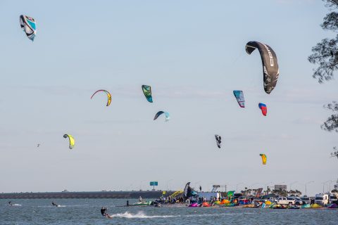 kiteboarding kites above the water