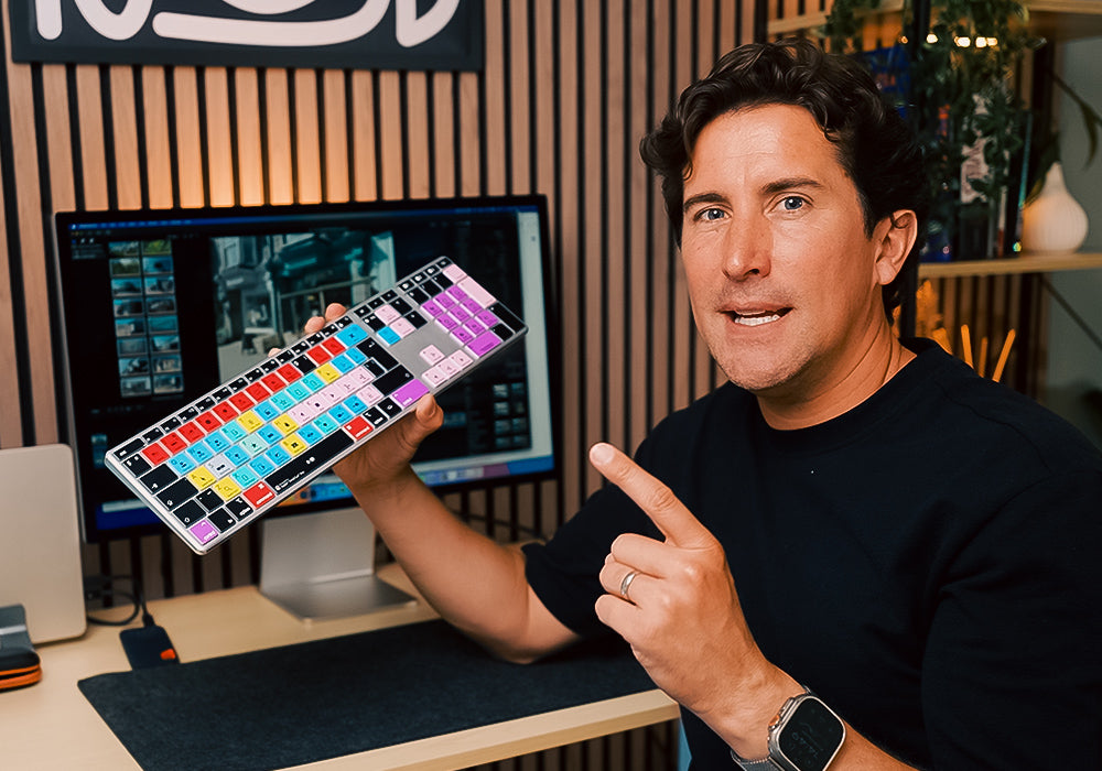 Mark from Editors Keys holding a Final Cut Pro wireless backlit editing keyboard