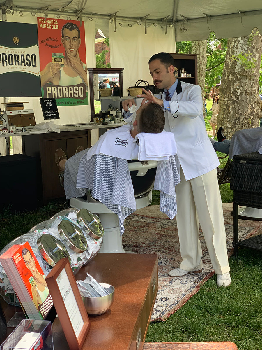 Proraso Master Barber Michael Haar applying shaving cream with a brush to a client reclined in a barber chair 