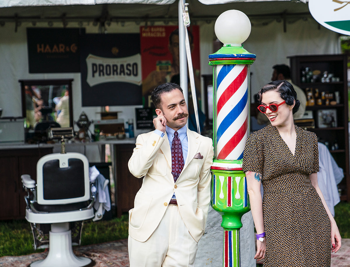 Proraso Master Barber Michael Haar posing next to a vintage barber pole outside