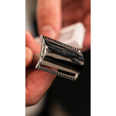 Man holding a double edge safety razor