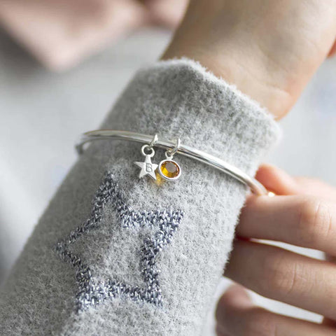 image shows child's personalised star birthstone bracelet with the November Topaz Birthstone
