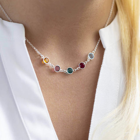 Model wears sterling silver family birthstone necklaces with five Swarovski birthstones.