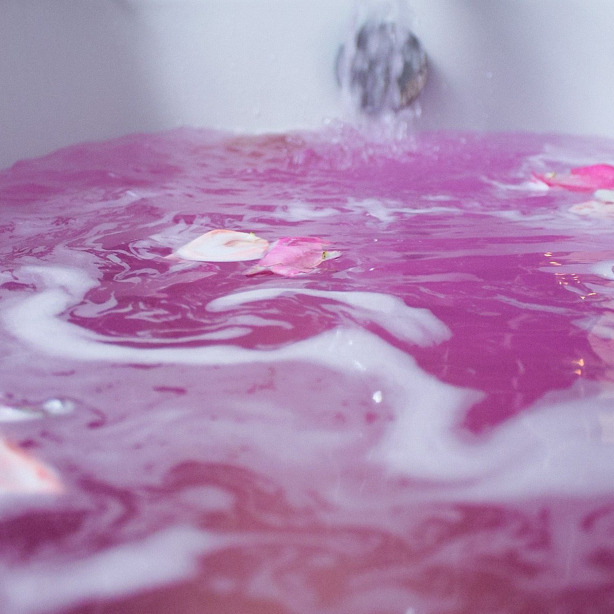 pink bath bomb in water