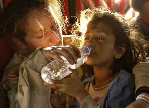 refugee girl drinking water