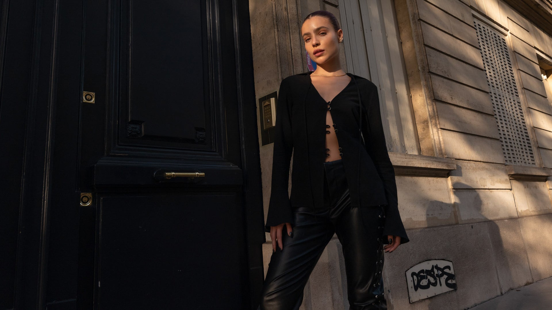 woman wearing a black shirt with black vegan leather trousers