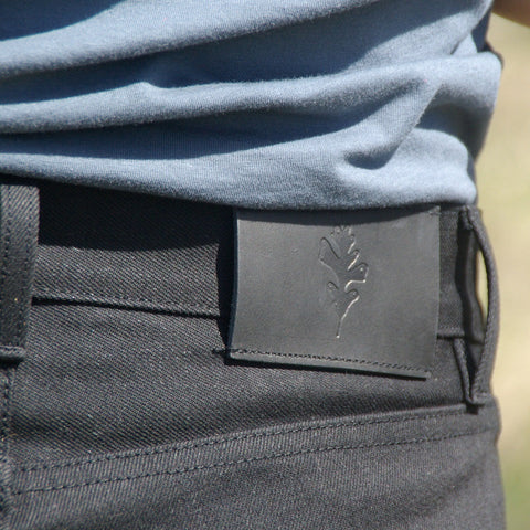 Oak leaf leather patch on black selvedge jeans