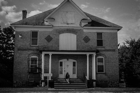 Amanda sits on the steps of the boarding school where her grandparents met. 