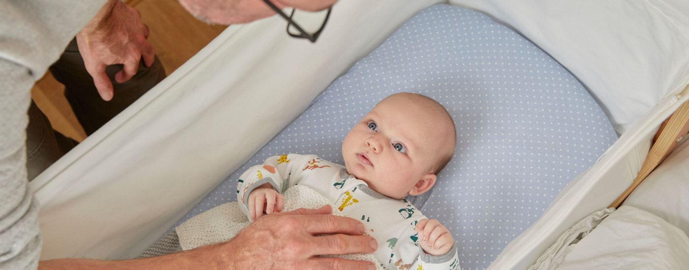 Dad putting baby to bed