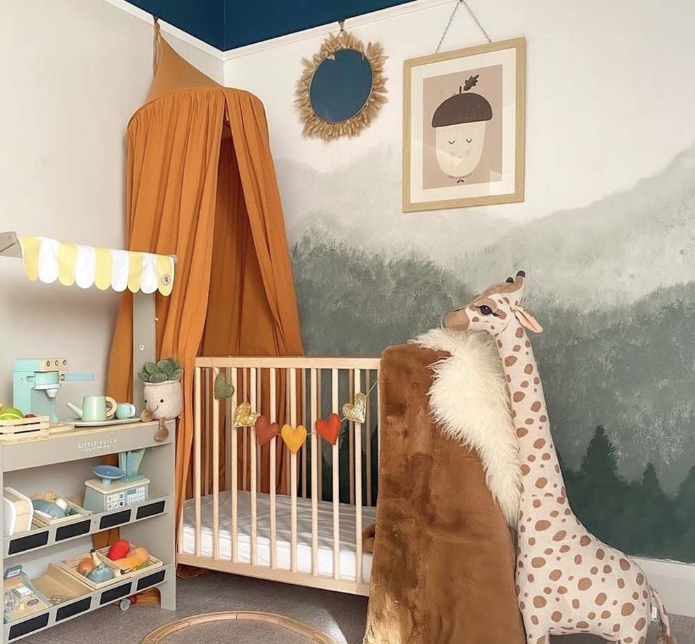 Nursery with hand painted mountain mural