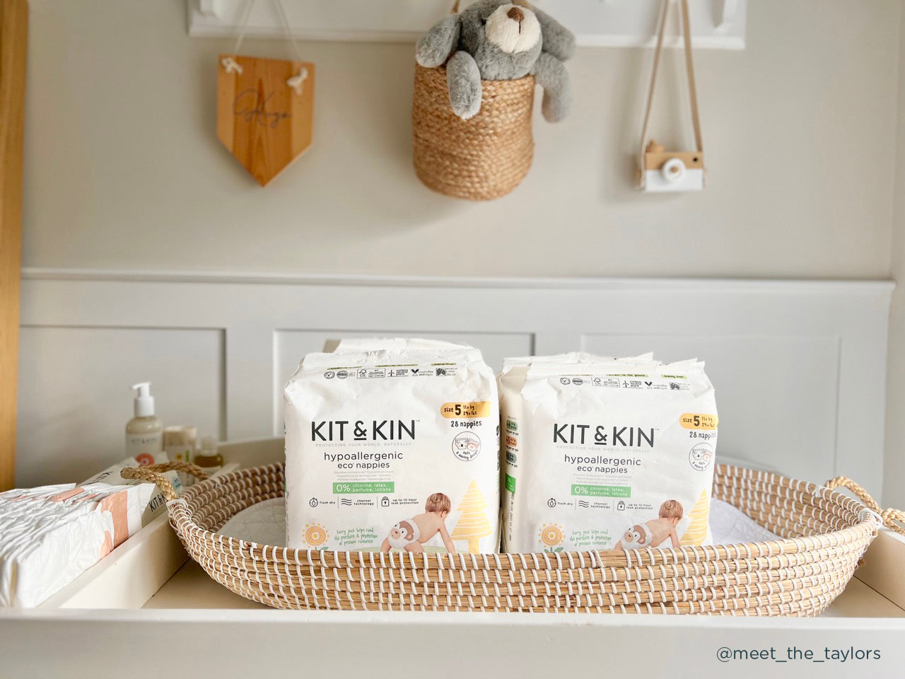 Kit & Kin size 5 eco nappies in paper packaging on changing table