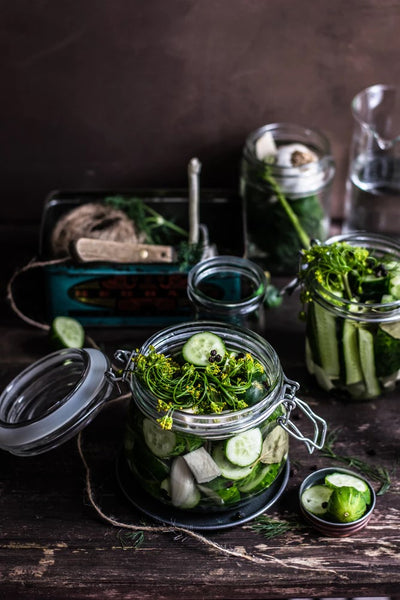 A jar of cucumbers being pickled
