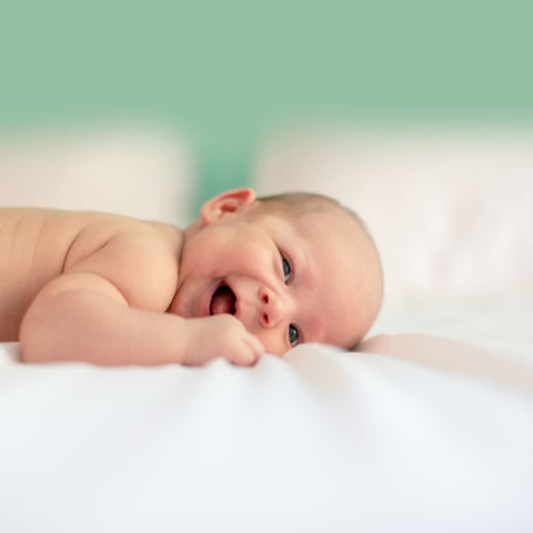 baby tummy time smiling