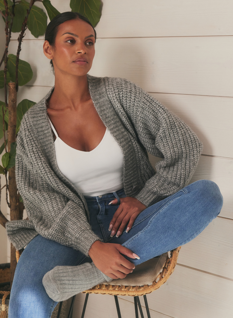 Woman sits on chair wearing LOVALL Mid Blue Lift & Shape Jeans