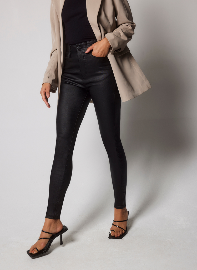 Model wears the Coated Jeans with Heels.