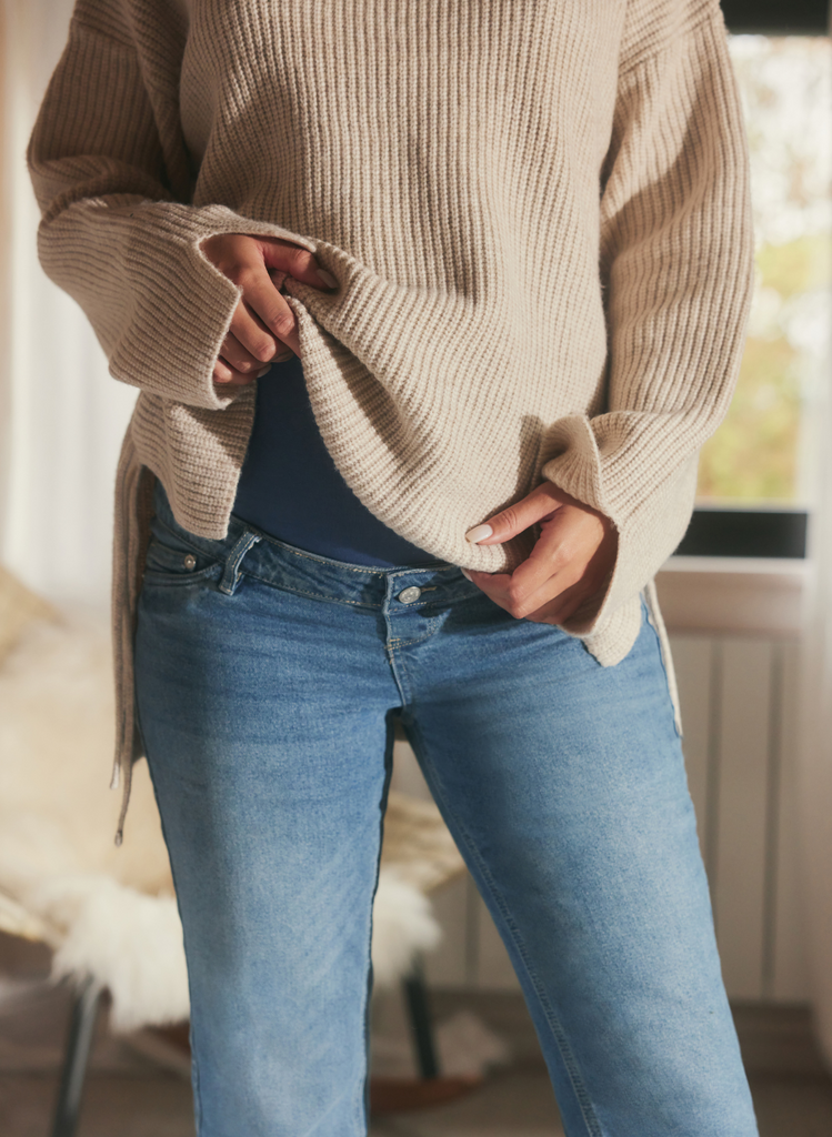 Close up image of Maternity Straight Leg Jeans in Light Blue - around the over the bump band.