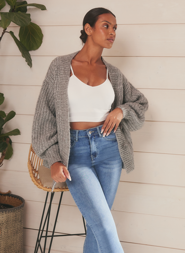 Model wears Light Blue Lift & Shape Jeans, with white crop top and great knitted cardigan. 