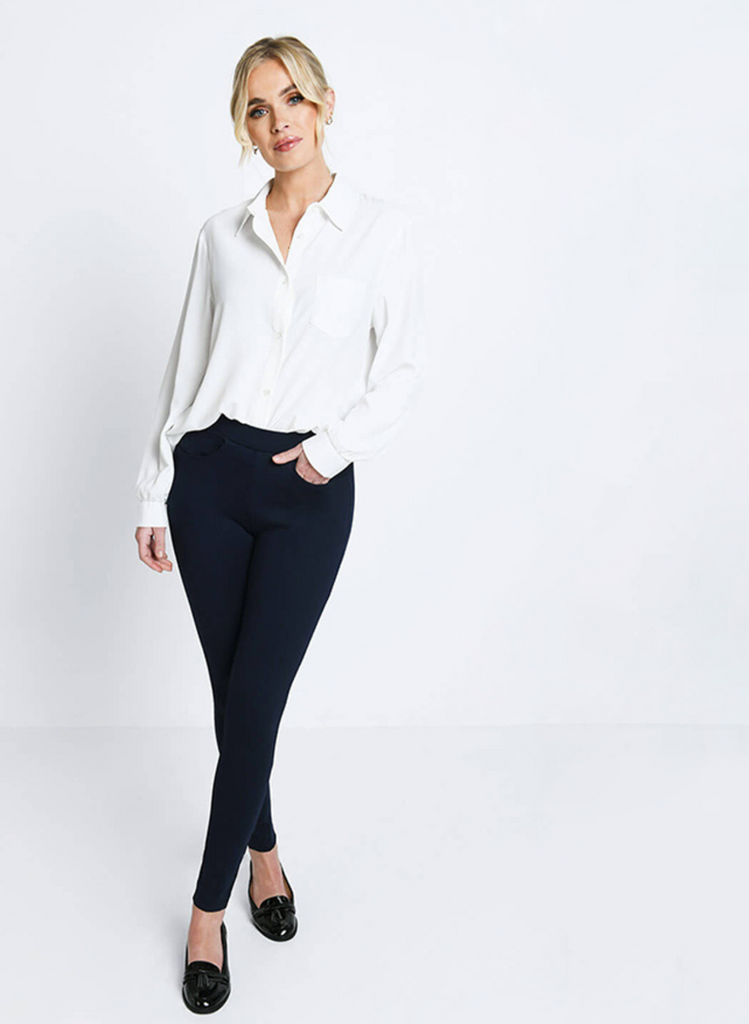 Woman wears Black Treggings with a white shirt and black shoes.