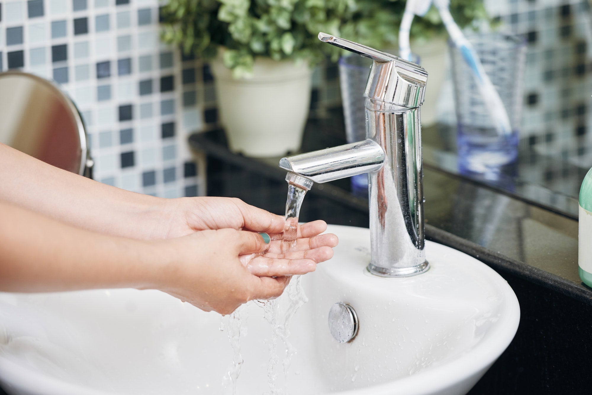 woman washing hands in bathroom