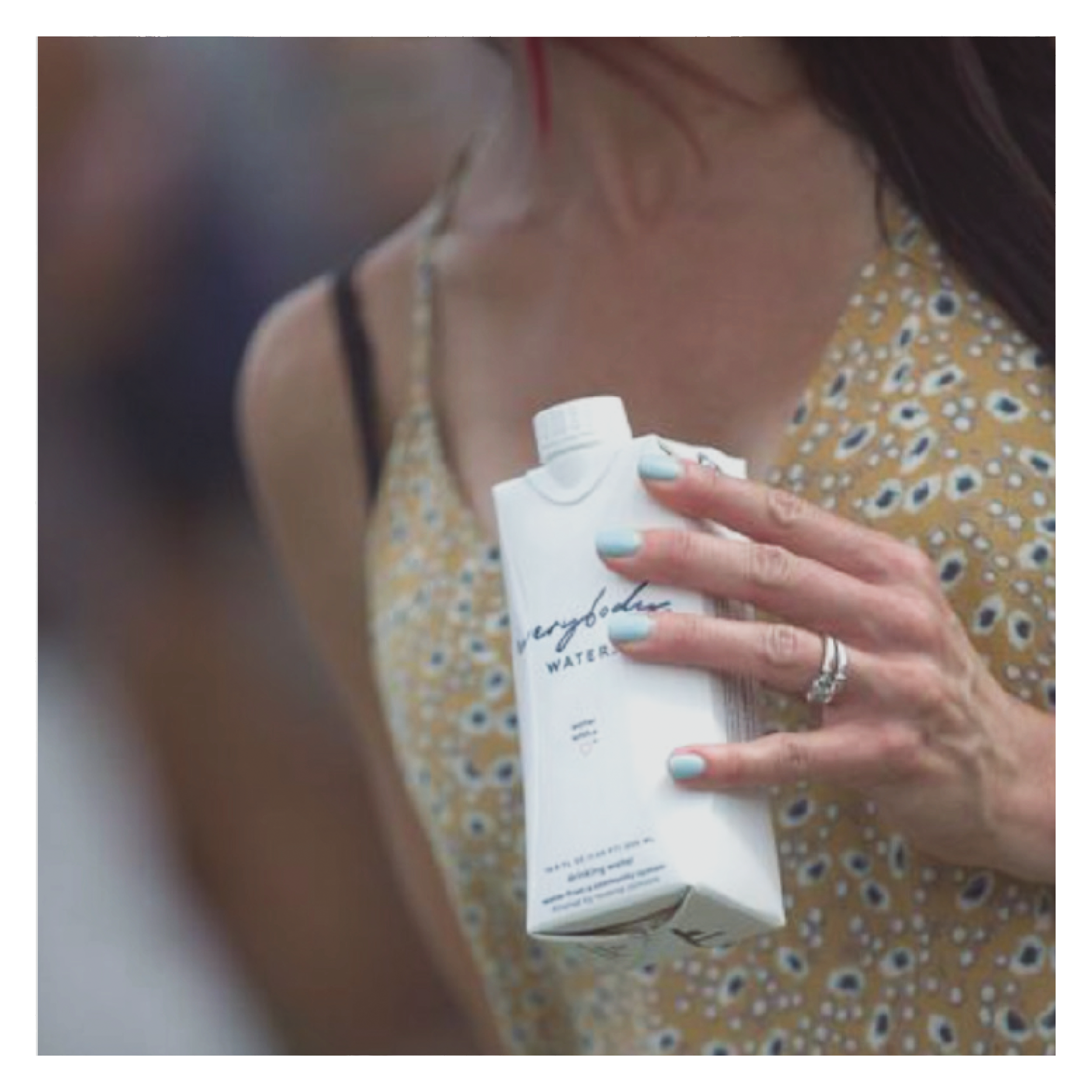 lady holding carton of everybody water