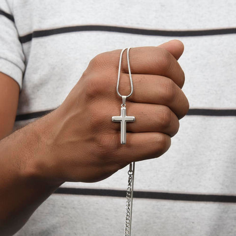 Man Holding Silver Cross Necklace