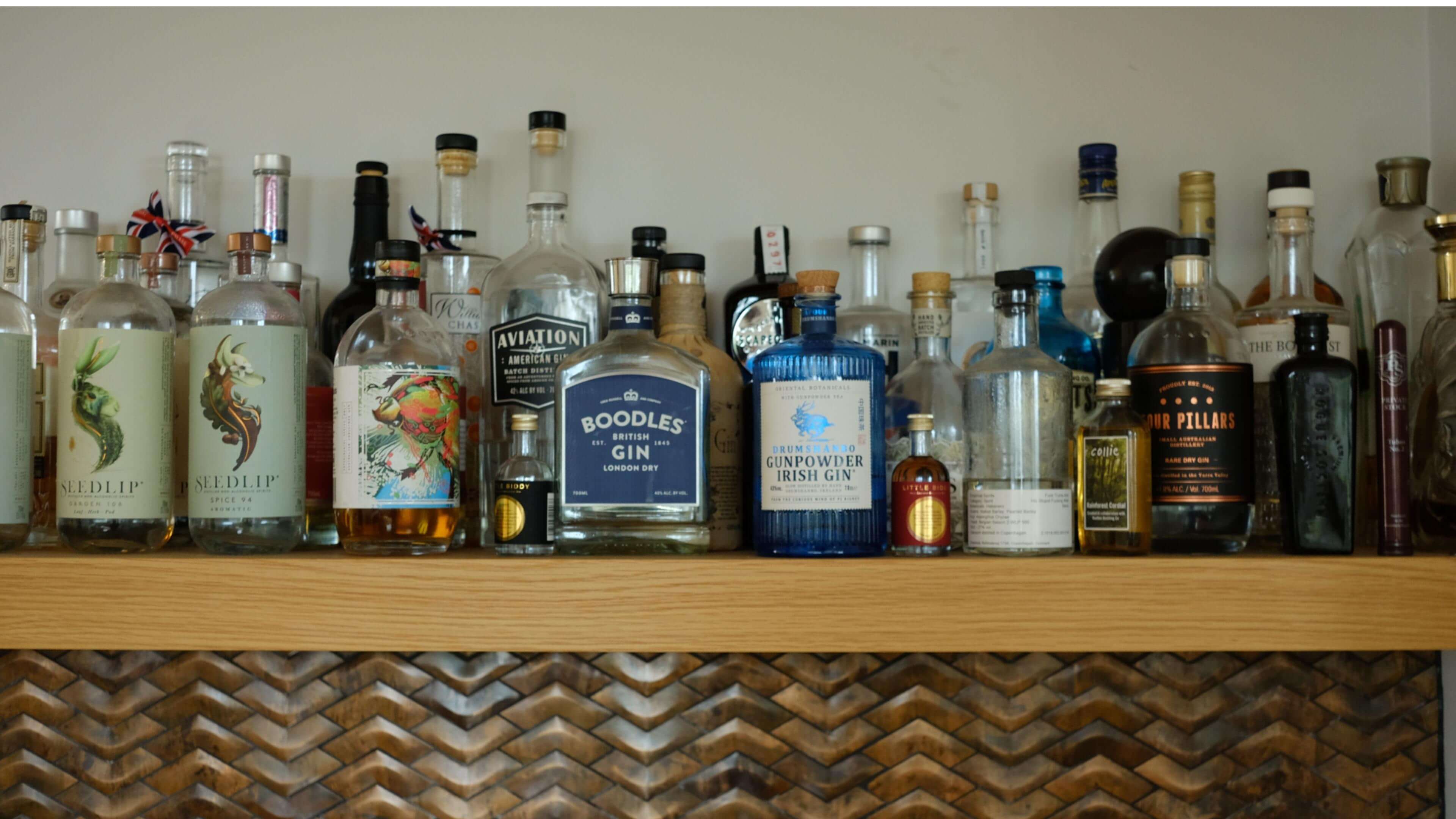 Image of Sid's drink shelf at home, with bottles taking up the whole shelf