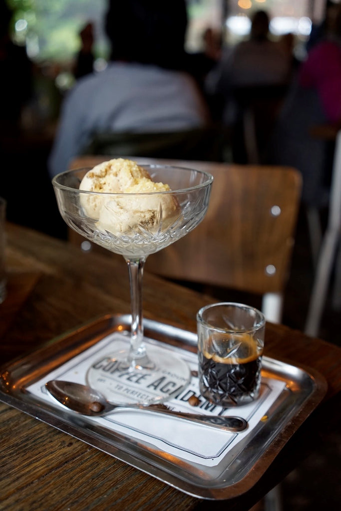 coffee ice cream in a glass bowl next to an espresso